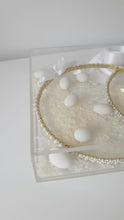 Load and play video in Gallery viewer, Evelyn (Gold) Stefana tied together with a white satin ribbon paired with a personalised acrylic keepsake Stefanothiki box. Traditional almonds and rice included.