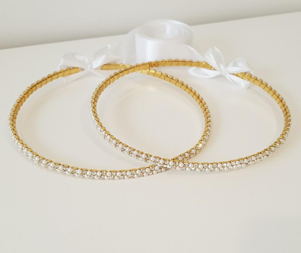 Evelyn (Gold) Stefana tied together with white satin ribbon.  Striking crystals with 3mm white pearls in a thick double row design on a Gold plated band.