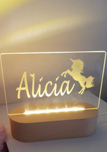 Load image into Gallery viewer, Unicorn night light with warm white lighting and personalised name. Oval wood look base with LED lighting
